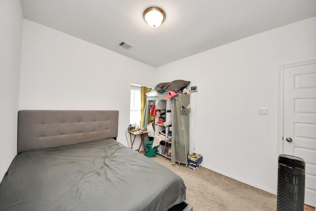 bedroom featuring visible vents, baseboards, and carpet floors