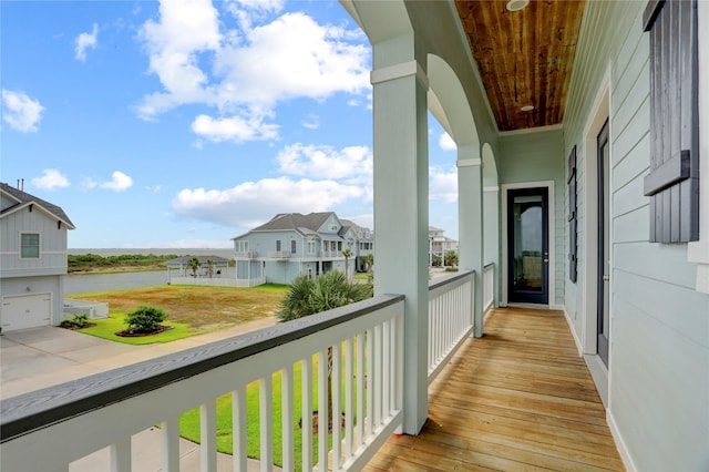 balcony featuring a water view and a residential view