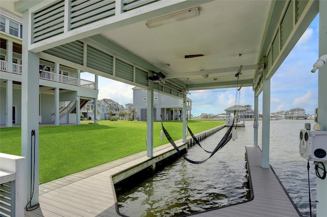 view of dock featuring a water view, boat lift, a yard, and a residential view