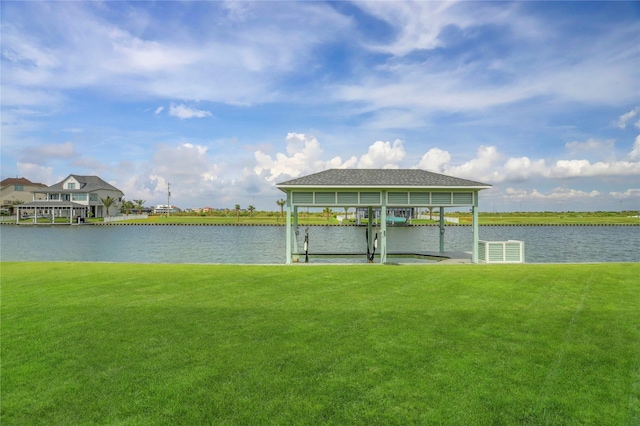 dock area with boat lift, a water view, and a lawn