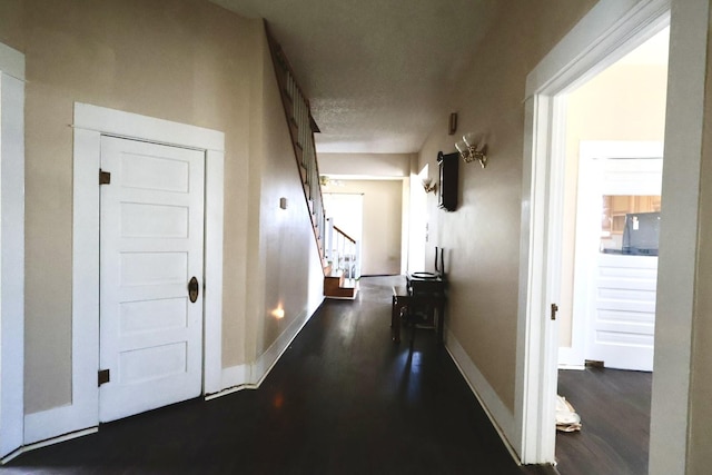1811 Beasley W End Rd, Beasley, TX 77417 - corridor with stairs, dark wood finished floors, baseboards, and a textured ceiling