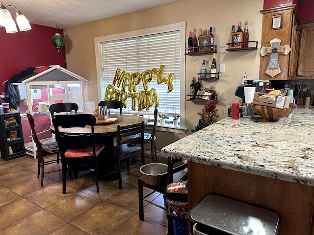 dining space with dark tile patterned flooring
