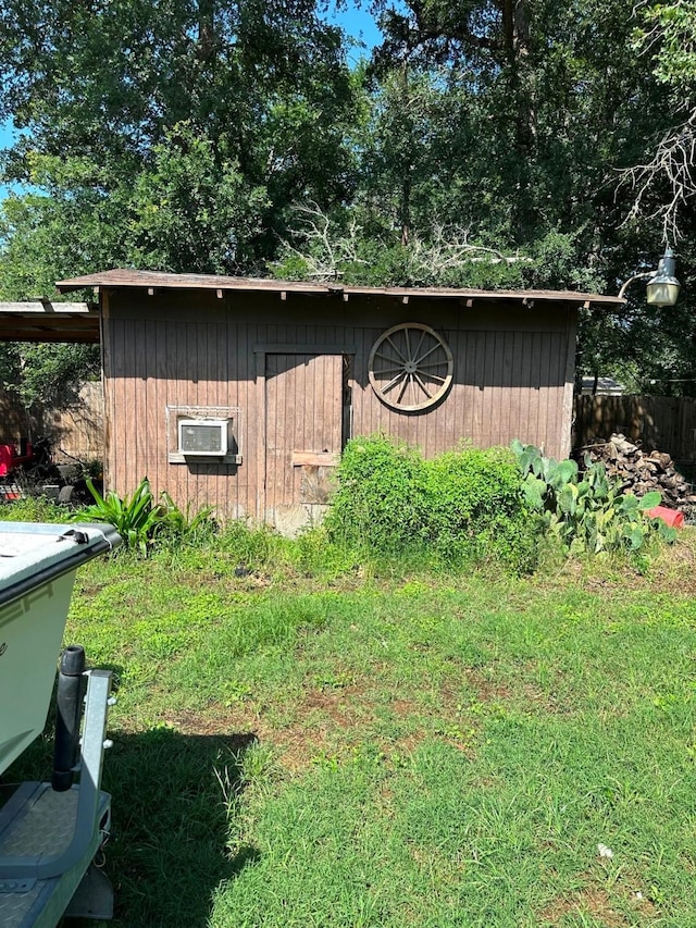 view of shed featuring fence