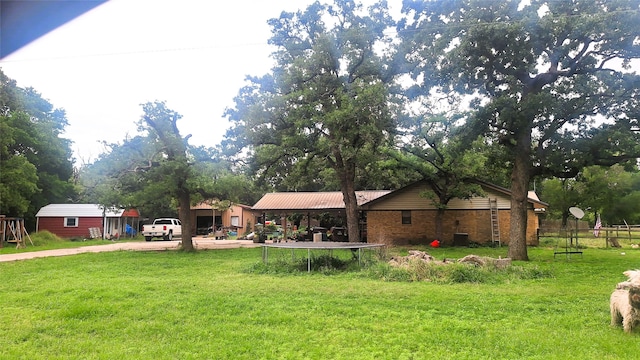 view of front facade featuring a front yard and metal roof