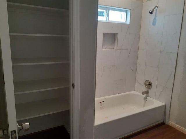 full bath with tub / shower combination and wood finished floors
