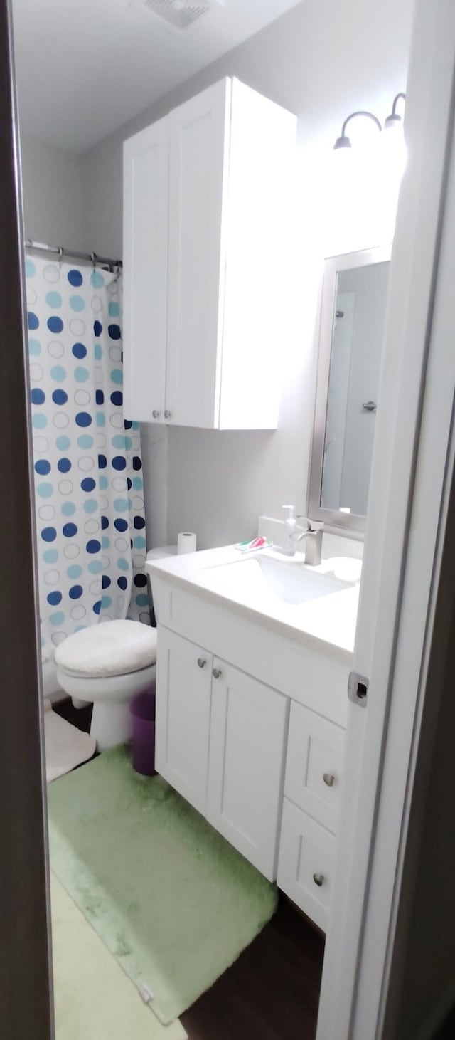full bath with toilet, a shower with curtain, tile patterned floors, visible vents, and vanity