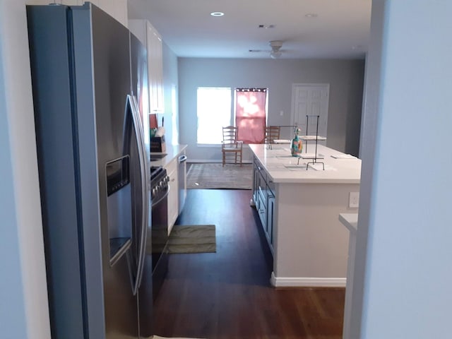 kitchen with dark wood-style floors, light countertops, stainless steel refrigerator with ice dispenser, and a ceiling fan