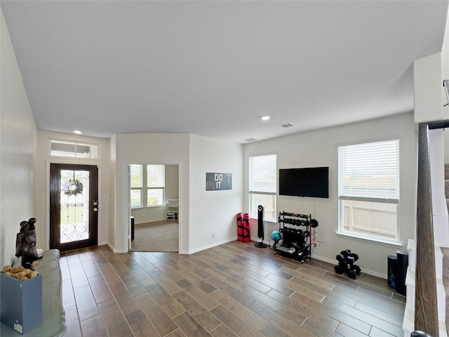 foyer with plenty of natural light, baseboards, wood finished floors, and recessed lighting