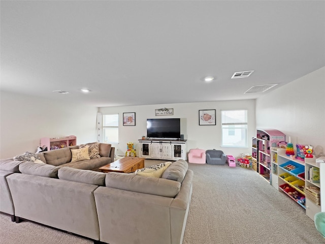 living room with carpet floors, visible vents, and recessed lighting