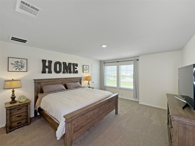 bedroom featuring baseboards, visible vents, and light colored carpet