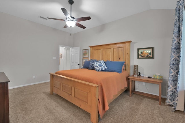 bedroom featuring vaulted ceiling, light carpet, baseboards, and a ceiling fan