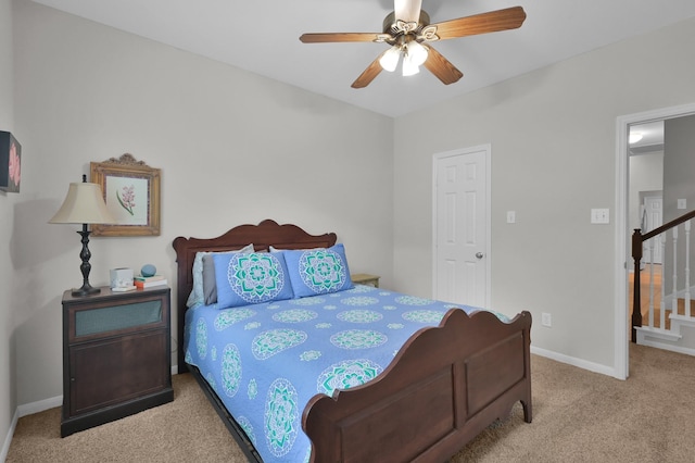 carpeted bedroom with baseboards and ceiling fan
