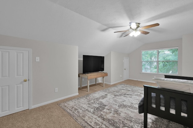 bedroom featuring carpet floors, lofted ceiling, baseboards, and a ceiling fan