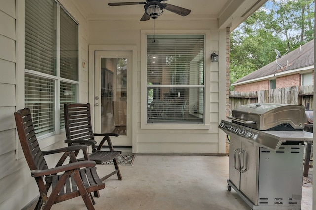 view of patio featuring grilling area, fence, and ceiling fan