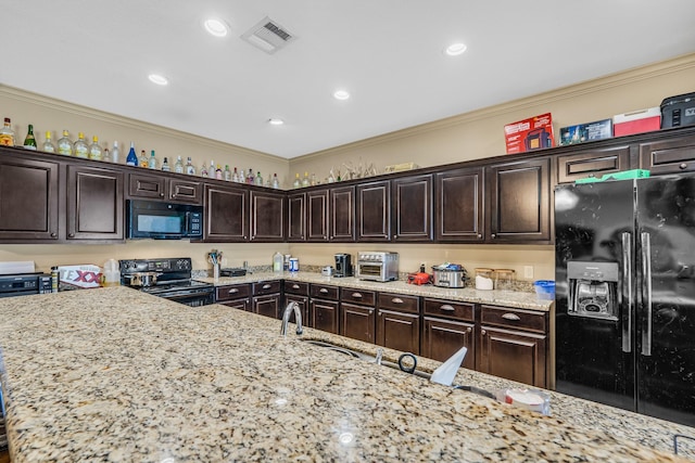 3338 Cullen Trl, College Station, TX 77845 - kitchen featuring black appliances, crown molding, visible vents, and dark brown cabinetry