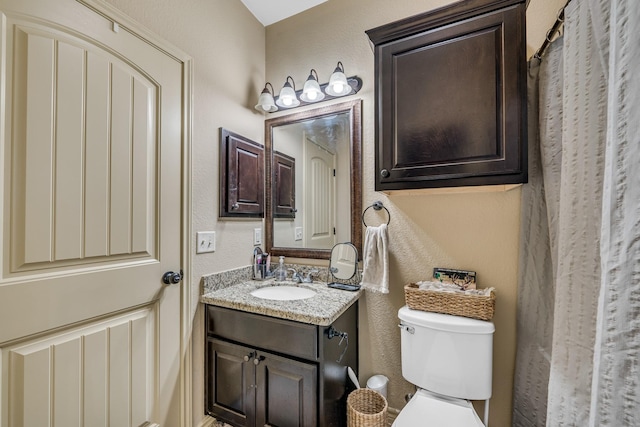 3338 Cullen Trl, College Station, TX 77845 - bathroom with toilet, vanity, and a textured wall