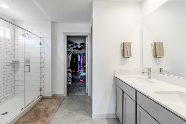 13938 Red River Dr, Baytown, TX 77523 - full bathroom with a shower stall, baseboards, double vanity, and a sink