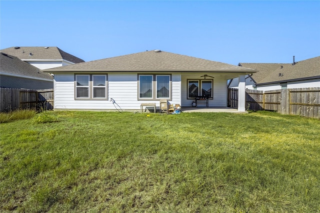 13938 Red River Dr, Baytown, TX 77523 - rear view of house with a patio, a lawn, and a fenced backyard