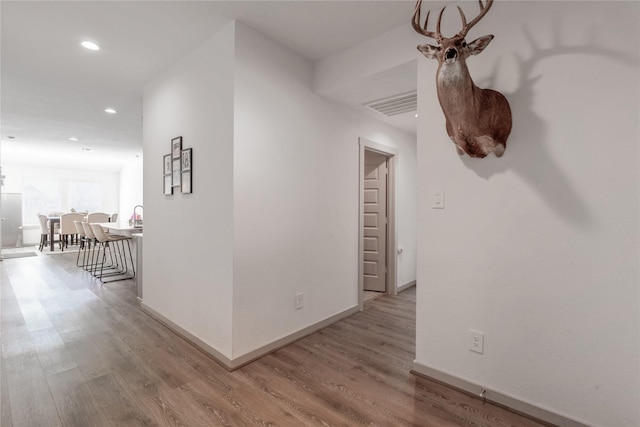 13938 Red River Dr, Baytown, TX 77523 - corridor with baseboards, recessed lighting, visible vents, and wood finished floors