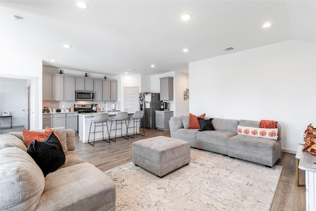 13938 Red River Dr, Baytown, TX 77523 - living room featuring light wood finished floors, visible vents, and recessed lighting