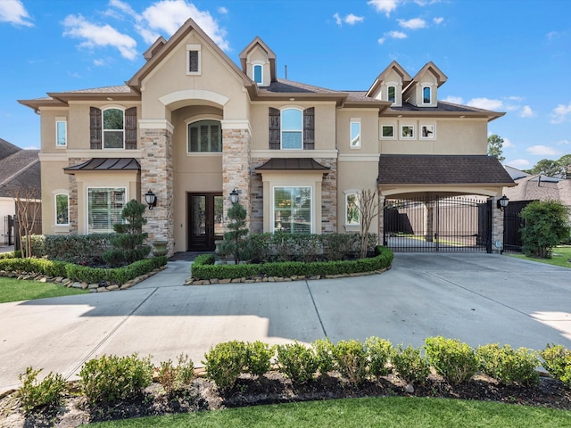 view of front facade featuring stone siding, stucco siding, french doors, and a gate