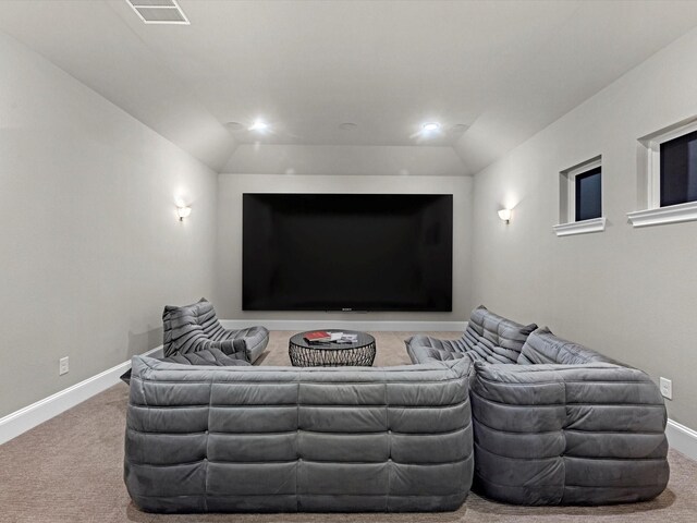 home theater with baseboards, visible vents, carpet floors, and vaulted ceiling