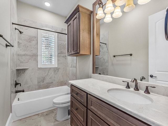 bathroom featuring toilet, marble finish floor, vanity, and shower / washtub combination