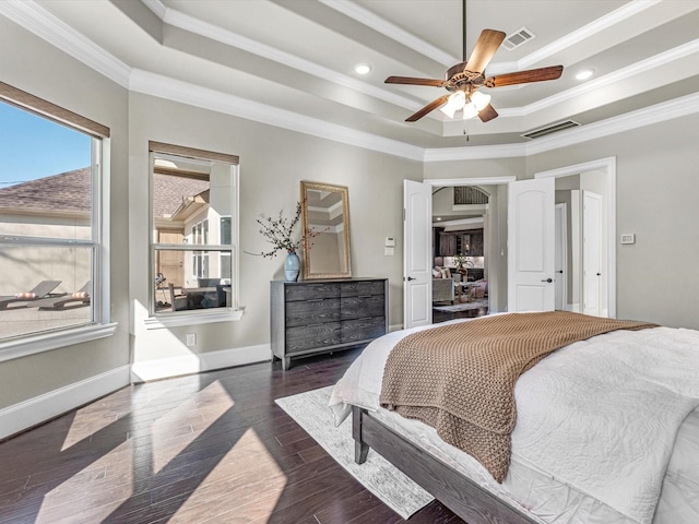 bedroom with crown molding, visible vents, and a raised ceiling