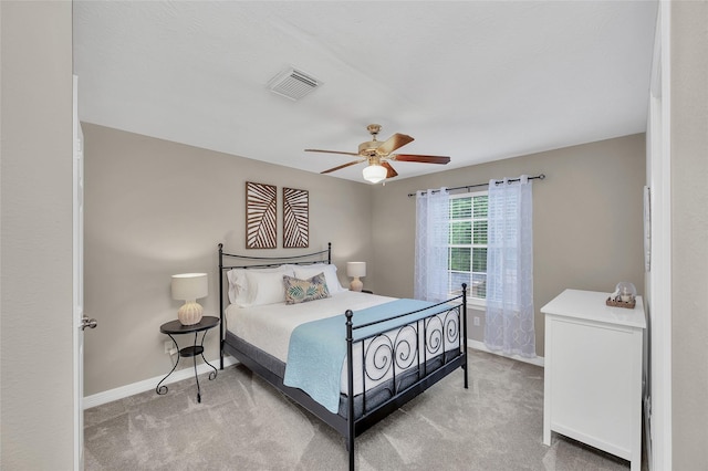 carpeted bedroom featuring baseboards and ceiling fan