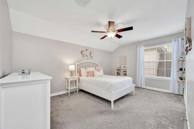 bedroom with baseboards, light carpet, vaulted ceiling, and ceiling fan