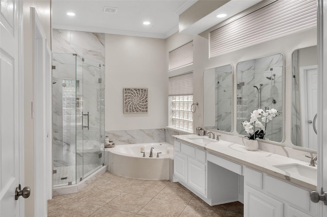 full bath with a marble finish shower, a bath, ornamental molding, double vanity, and recessed lighting