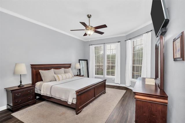 bedroom featuring dark wood-style floors, crown molding, baseboards, and a ceiling fan