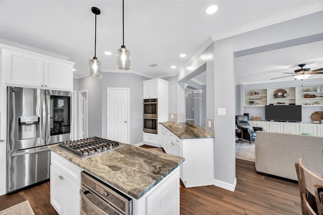 kitchen with stainless steel appliances, ornamental molding, dark stone counters, dark wood-type flooring, and open floor plan