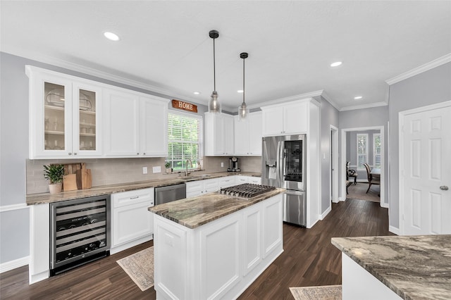 kitchen with wine cooler, stainless steel appliances, a sink, tasteful backsplash, and ornamental molding