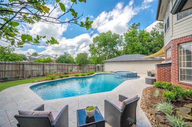view of swimming pool with a fenced backyard, a patio area, and a pool with connected hot tub