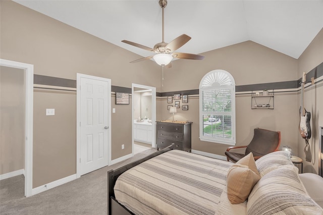 bedroom with vaulted ceiling, light carpet, baseboards, ceiling fan, and ensuite bathroom