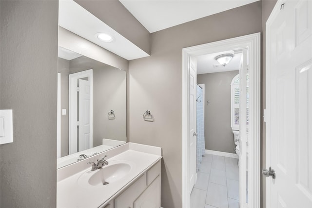 full bath with vanity, baseboards, and toilet