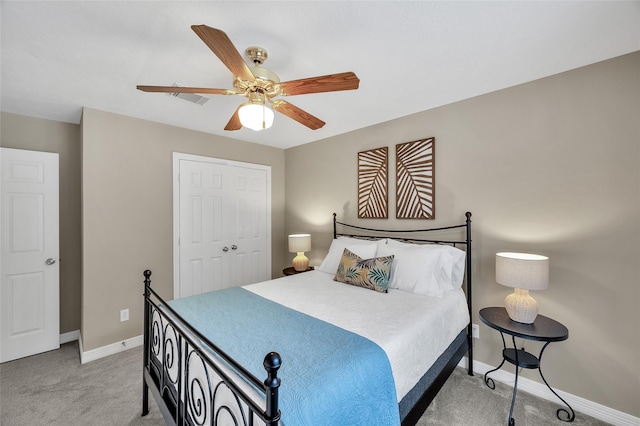 bedroom with light carpet, baseboards, a closet, and ceiling fan