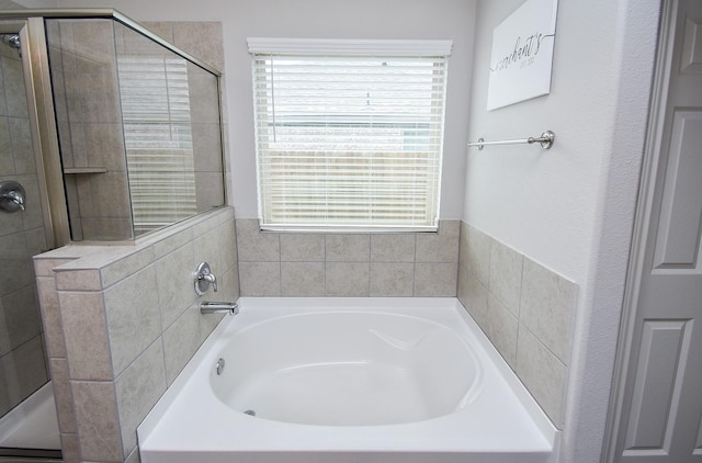 full bathroom featuring a garden tub and a stall shower