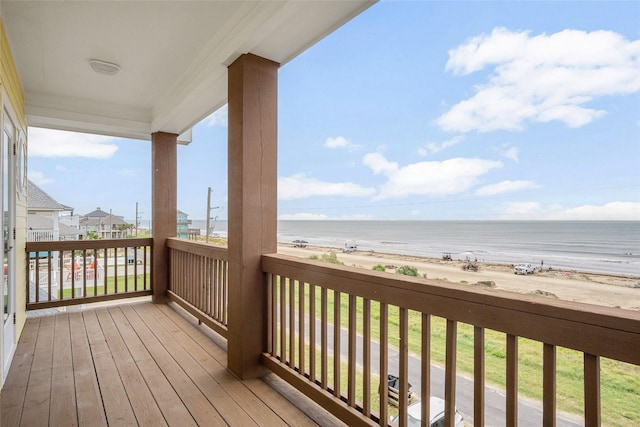 deck featuring a water view and a beach view