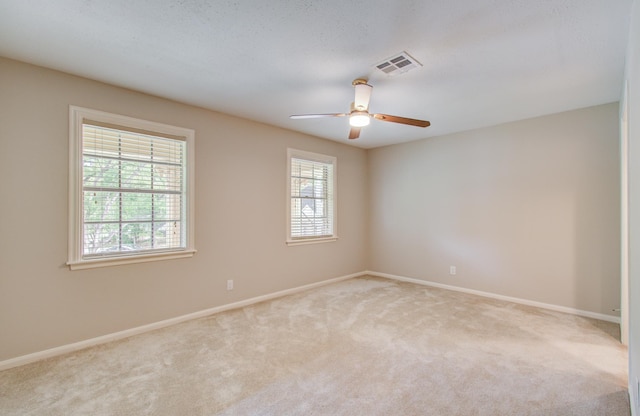 11022 Riverview Dr, Houston, TX 77042 - carpeted empty room featuring visible vents, baseboards, and a healthy amount of sunlight