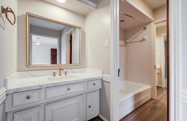 11022 Riverview Dr, Houston, TX 77042 - full bath featuring vanity, wood finished floors, bathtub / shower combination, and ceiling fan