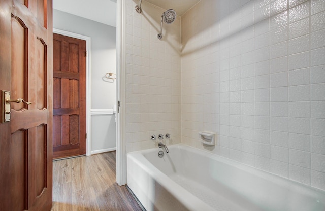 11022 Riverview Dr, Houston, TX 77042 - bathroom featuring bathtub / shower combination and wood finished floors