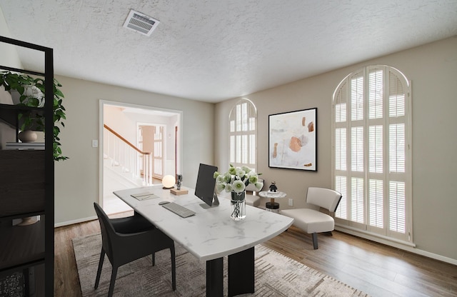 11022 Riverview Dr, Houston, TX 77042 - office area featuring a textured ceiling, visible vents, wood finished floors, and baseboards