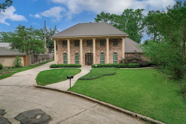 11022 Riverview Dr, Houston, TX 77042 - greek revival inspired property featuring brick siding, fence, and a front yard