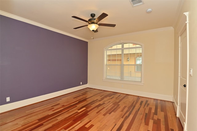 unfurnished room with baseboards, ornamental molding, and visible vents