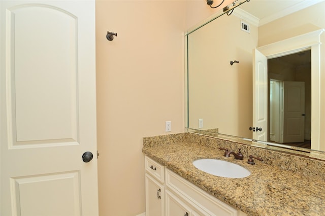 bathroom with crown molding, vanity, and visible vents