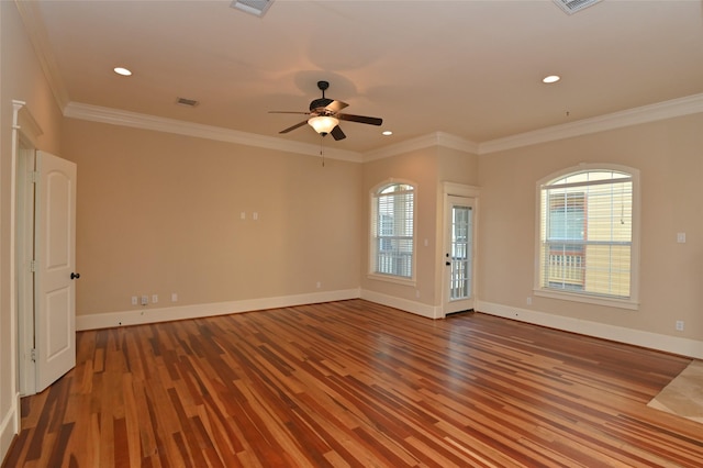 unfurnished room featuring visible vents, wood finished floors, baseboards, and ceiling fan