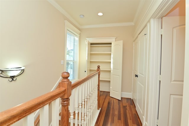 hallway featuring an upstairs landing, crown molding, dark wood-type flooring, baseboards, and recessed lighting