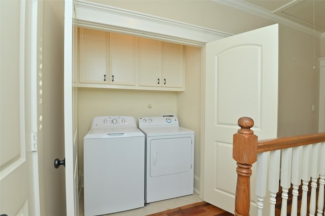 laundry area featuring separate washer and dryer, ornamental molding, and attic access